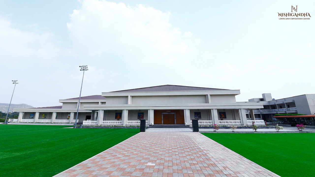 Elegant open-air turf wedding setup in Pune with floral décor, ambient lighting, banquet seating, and a premium celebration atmosphere under the evening sky.