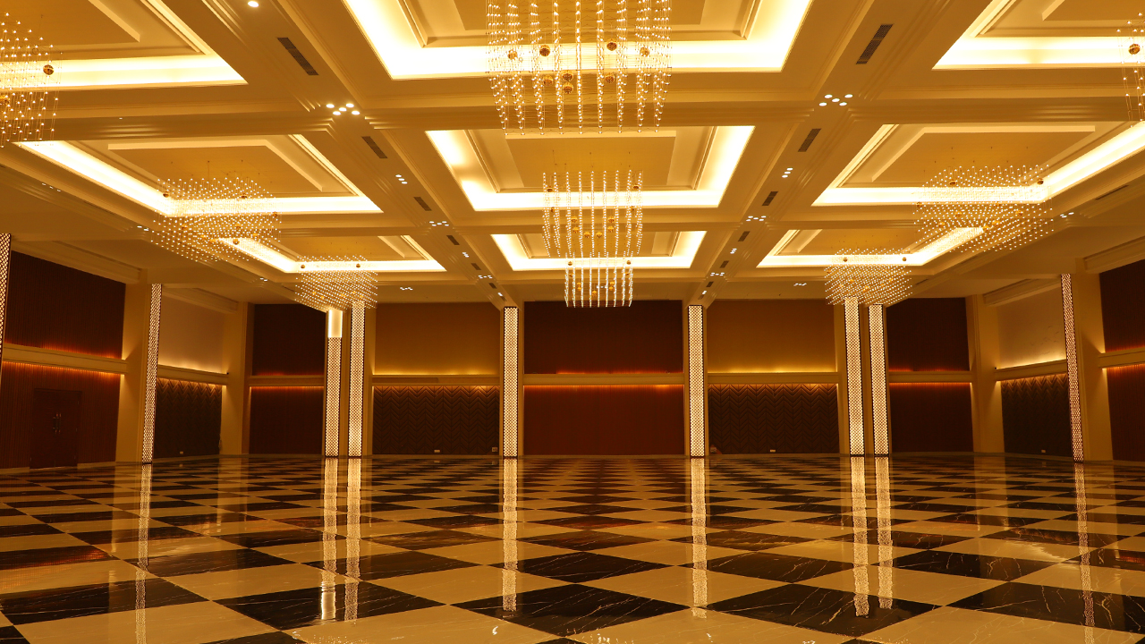 Elegant premium event venue in Pune with luxurious banquet setup, modern lighting, floral décor, spacious seating arrangement, and beautifully designed outdoor lawn for weddings and celebrations.